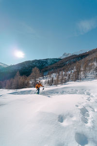 Man skiing on snow covered landscape