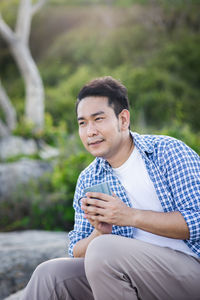 Young man sitting outdoors