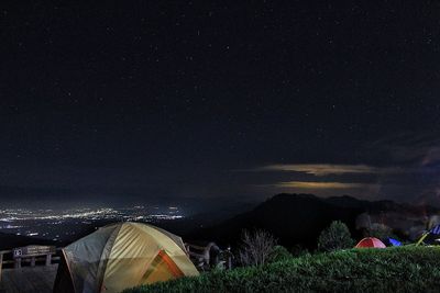 Tent on field against sky at night