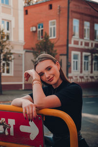 Portrait of young woman in city