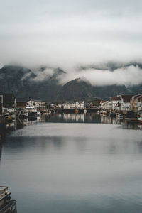 Scenic view of sea by buildings against sky