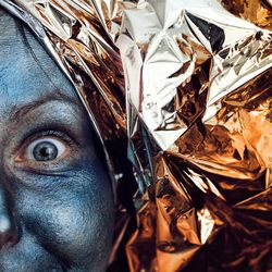 Close-up of painted face woman with wrapping paper