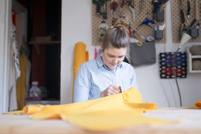 Woman sewing in workshop