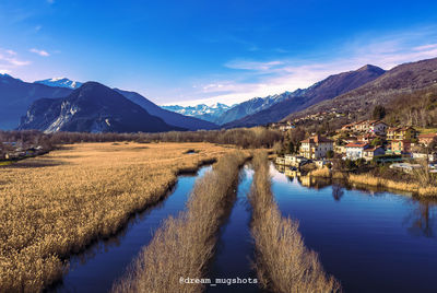 Panoramic view of lake and mountains against blue sky