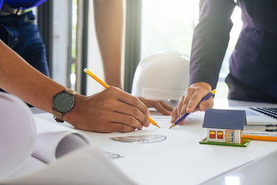 Midsection of woman working on table