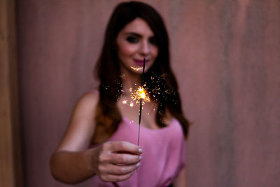 Portrait of young woman holding umbrella