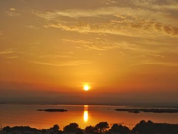 Scenic view of sea against romantic sky at sunset