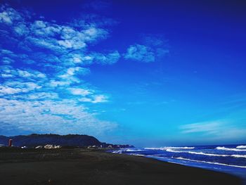 Scenic view of beach against blue sky