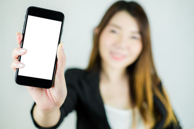 Midsection of woman using smart phone