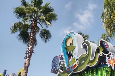 Low angle view of palm trees against sky