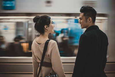 Side view of couple looking at camera