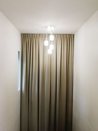 Illuminated lamp on wall at home