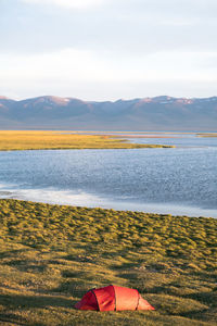 Scenic view of lake and mountains against sky