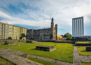 View of buildings against cloudy sky