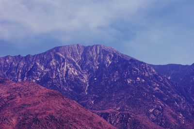 Scenic view of mountains against cloudy sky