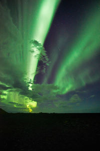 Low angle view of illuminated mountain against sky at night