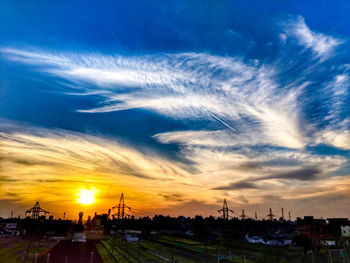 Silhouette buildings against sky during sunset