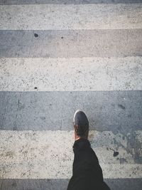 Low section of man standing on street