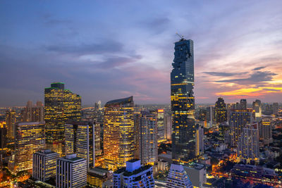 Illuminated buildings in city against cloudy sky , cityscape bangkok thailand