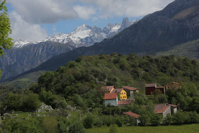 Scenic view of trees and mountains against sky