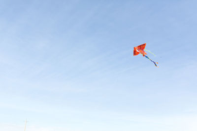 Low angle view of red kite flying in sky