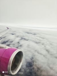 Airplane flying over cloudscape against sky