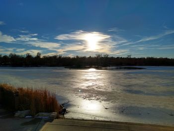 Scenic view of lake against sky during winter