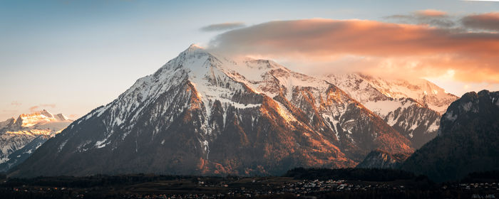 Panoramic view of snowcapped mountains against sky during sunset