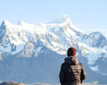 Man in torres del paine national park, chile, with snowy mountains in background