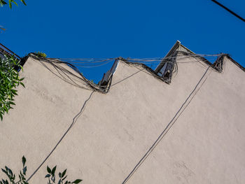 Low angle view of building against clear blue sky