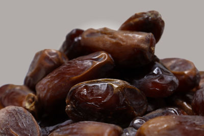 Close-up of roasted coffee beans against white background