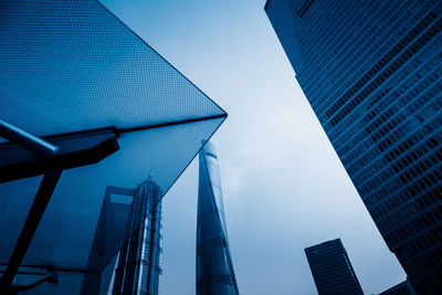 Low angle view of modern buildings against clear blue sky