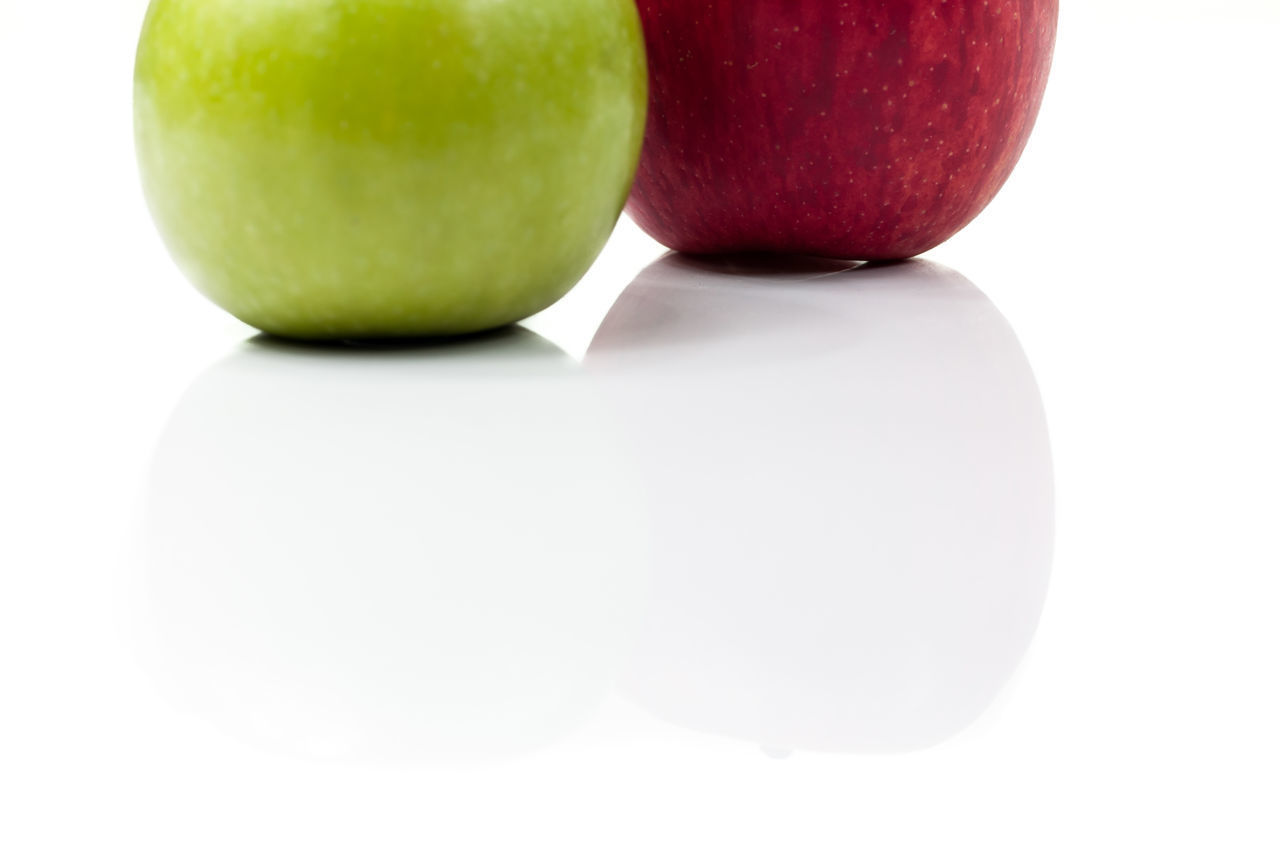 CLOSE-UP OF APPLES ON WHITE BACKGROUND