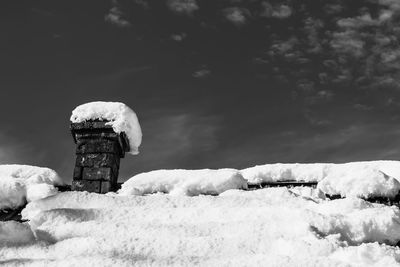 Snow covered field against sky