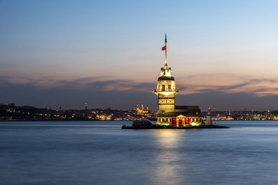 Illuminated buildings in city at waterfront in istanbul 