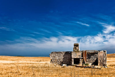 Old ruin on field against sky