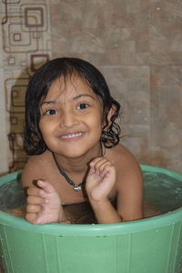 Portrait of a smiling young woman in bathroom