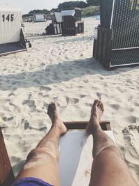 Low section of man relaxing on floor