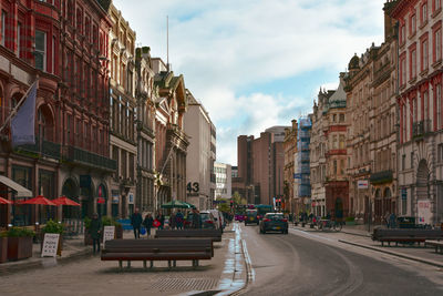 Street amidst buildings in city against sky