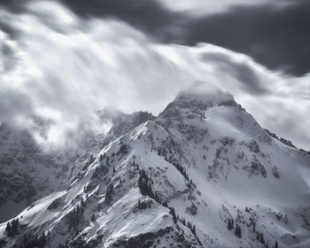 Scenic view of snow covered mountains against sky