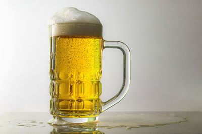 Close-up of beer glass on table