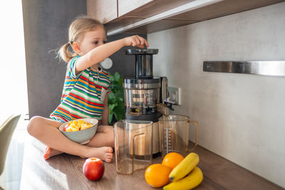 Midsection of woman holding food at home