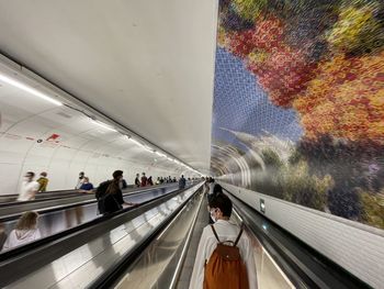 People at railroad station platform seen through glass