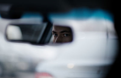 Reflection of man mirror at car