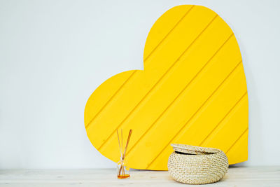 Close-up of yellow umbrella on table against clear sky