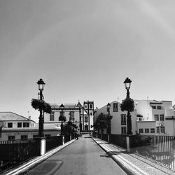 Street amidst buildings against clear sky