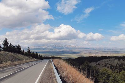 Road amidst landscape against sky