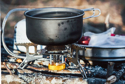 Close-up of tea cup on barbecue grill