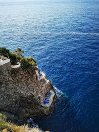 High angle view of rocks by sea