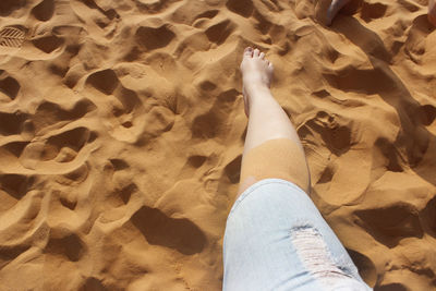 Low section of man on sand